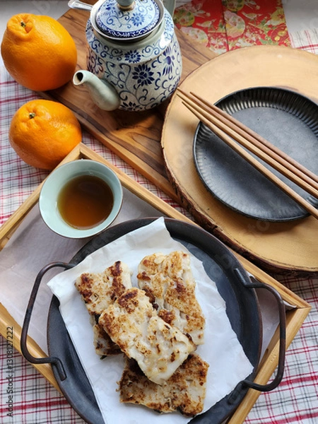 Obraz Homemade festive cuisine. Fried Radish Cake. Favourite dish during Chinese New Year, after steaming and cooled down, it's usually kept in the fridge overnight to set it harder and stir fried later