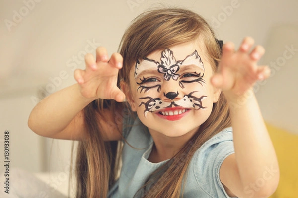 Fototapeta Portrait of funny girl with face painting on blurred background
