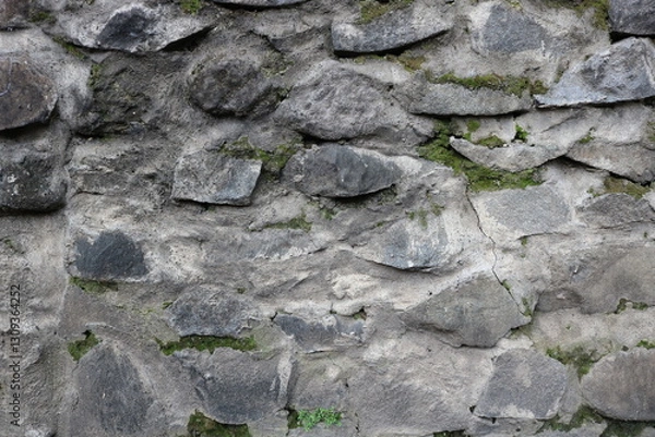 Obraz Close-up of rough stone wall with irregular shapes and natural textures. Perfect for backgrounds, architectural designs, and rustic-themed projects.