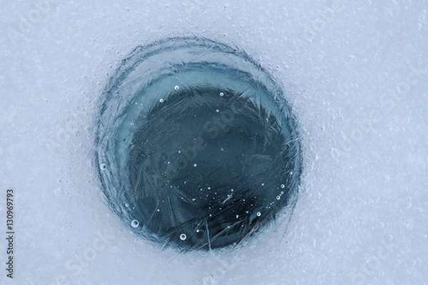 Fototapeta frozen hole on the surface of the pond