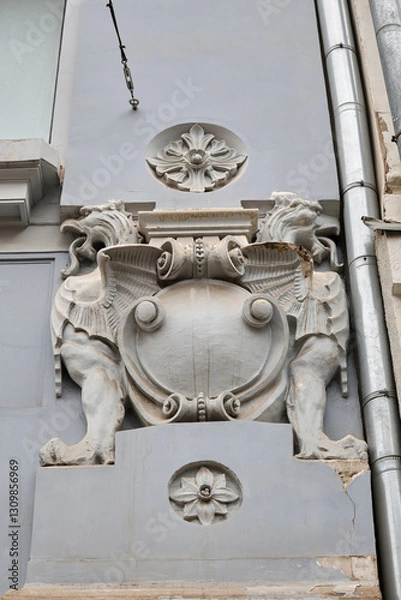 Obraz sculpture on the facade of an old building