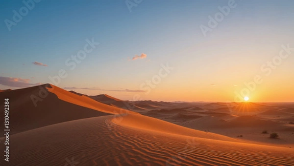 Fototapeta Breathtaking sunset over golden sand dunes, casting long shadows and creating a serene desert landscape.