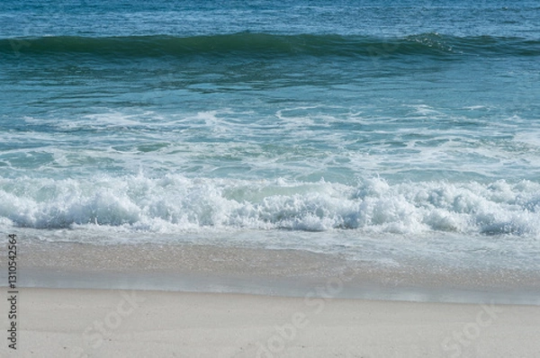 Fototapeta Small waves of Atlantic Ocean deep blue waters breaking on Praia Seca beach white sands shoreline under bright summer afternoon clear weather in Praia Seca district, Araruama, Rio de Janeiro - Brazil.