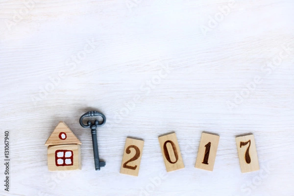 Fototapeta individual housing in 2017/ Concept finished house with a key, and digits on wooden plates denoting year 