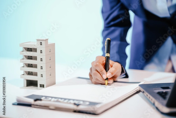 Fototapeta A female employee works at her desk in a real estate office, managing condo sales in the city. She communicates with clients, handles listings, and provides information about available properties