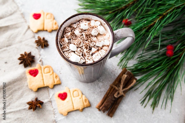 Fototapeta Cocoa with marshmallow and christmas decoration. On a stone back
