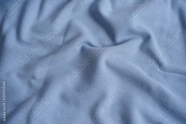 Fototapeta Texture of turquoise blue cotton pique fabric. Flat lay style, close up. Commonly use for t- shirt. Woven fabric characterized by a pattern of raised parallel cords or geometric designs. 