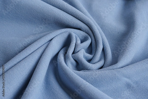 Fototapeta Texture of turquoise blue cotton pique fabric folded in a swirling pattern. Flat lay, close up.  Woven fabric characterized by a pattern of raised parallel cords or geometric designs. 