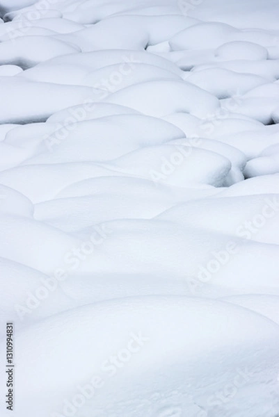 Fototapeta River rocks in a winter landscape covered in deep white snow