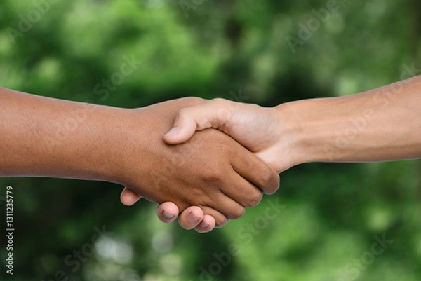 Obraz Hand shaking on natural green background. corporate concept to invest in the environment social and governance. Cooperation of organization environment for charity for Sustainable development goals.