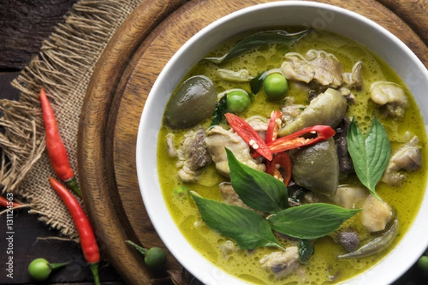 Fototapeta Thai food chicken green curry on dark wooden background. top view