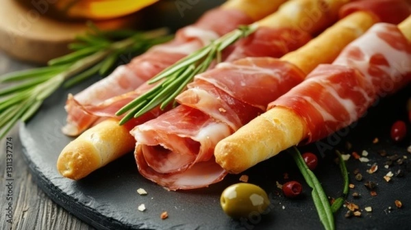 Fototapeta Close-up of prosciutto wrapped around golden