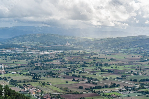 Fototapeta A large field with a few houses in the distance in Gubbio Viewpoint Italy Umbria