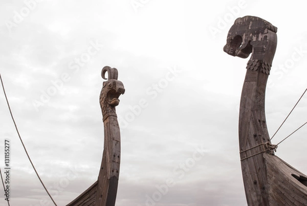 Fototapeta Viking warship at a shadow in the background of cloudy sky