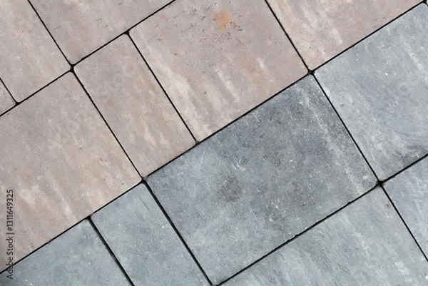 Fototapeta Multicolored paving slabs for road paving by mosaic on shop window