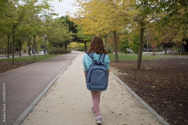 Obraz redhead girl hiking park with backpack. child backpacker walking in nature. Summer. Horizontal	