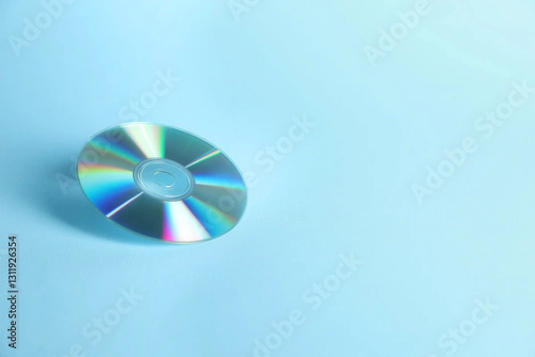 Fototapeta One shiny compact disc on light blue background. Space for text