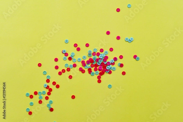 Obraz Red and green buttons on yellow paper
