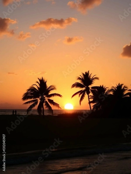 Fototapeta The sun setting over calm ocean waters, casting golden reflections along the sandy beach.