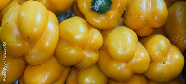 Fototapeta Yellow capsicum, also known as yellow bell pepper, is a vibrant and sweet variety of capsicum. It has a smooth, glossy skin and a firm, crisp texture