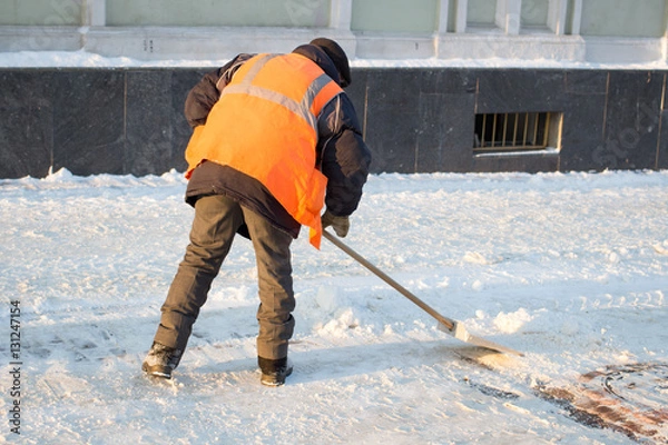 Obraz Janitor cleans the street of snow