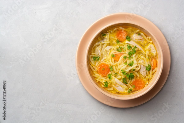 Fototapeta Chicken soup with noodles and vegetables in bowl on concrete background
