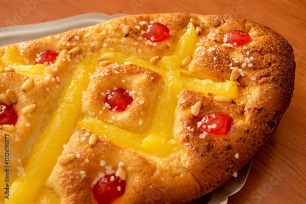 Fototapeta Close-up view of "Coca de Sant Joan" with cream, candied cherries and pine nuts, a festive Catalan sweet typical of the Saint John's Eve celebration