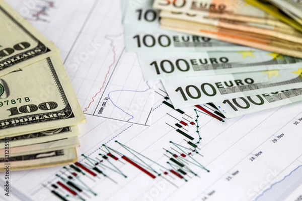 Obraz Concept of currency trading. .Hundred us dollar bills . Piles of euro bills. Currency us euro exchange chart under the bills. 200 euro bills, 100 euro fan shaped. Close up image.
