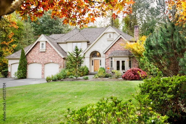 Fototapeta Suburban home from the front garden in early Autumn as the leaves begin to turn