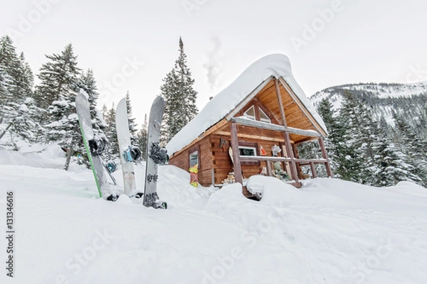 Fototapeta Snowboard at house chalets in winter forest with snow in mountai