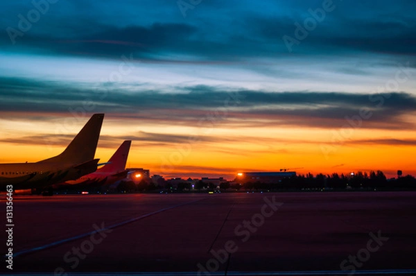 Obraz the silhouette of airplane are parking at air port in twilight sky background