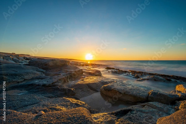 Obraz beautiful sunset with clear sky on a stony beach