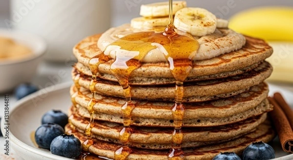 Fototapeta Stack of Pancakes with Banana and Syrup Being Poured on Top