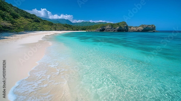 Fototapeta A tropical beach with golden sand and crystal-clear turquoise waters shimmering under the bright sun. Gentle waves ripple along the shore, creating a peaceful and relaxing paradise. Beautiful nature.