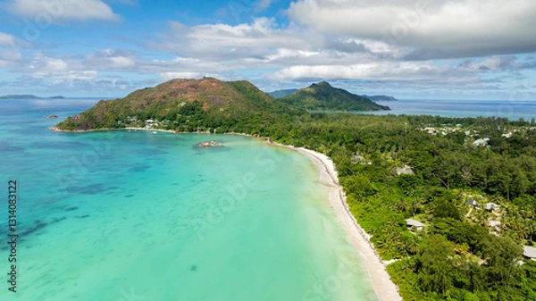 Fototapeta A sweeping curved coastline with green hills, a tranquil turquoise bay, and soft white sands. Praslin, Seychelles.