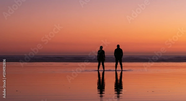 Obraz Silhouette of romantic couple standing together on peaceful beach during vivid colorful sunset twilight