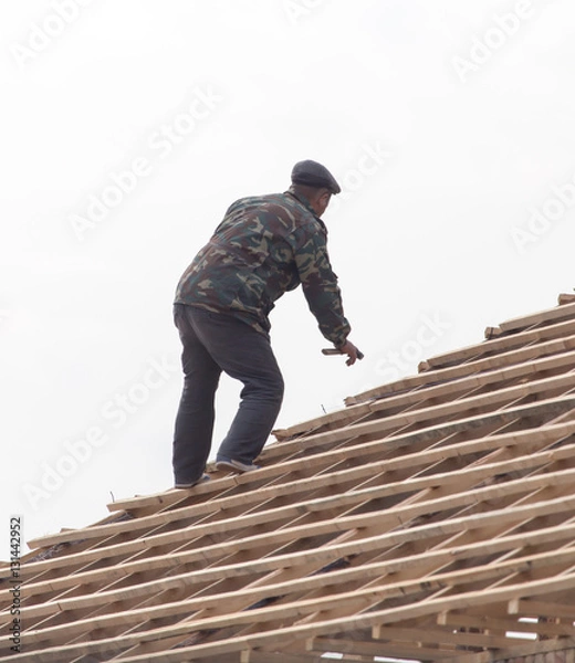 Fototapeta workers working on the roof