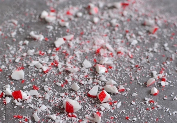 Obraz Crushed peppermint candy cane bits sprinkled on wax paper background