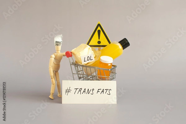 Fototapeta The idea of the dangers of foods containing large amounts of trans fats. The doll holds a basket with various trans fats and a warning sign.