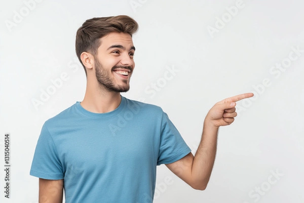 Fototapeta A handsome young man confidently pointing with his hand, showing a casual gesture