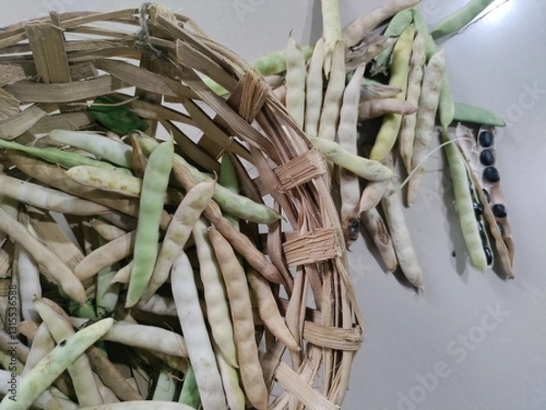 Fototapeta Black turtle bean pods in basket.