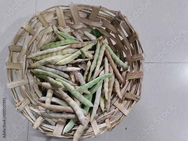 Fototapeta Black turtle bean pods in basket.