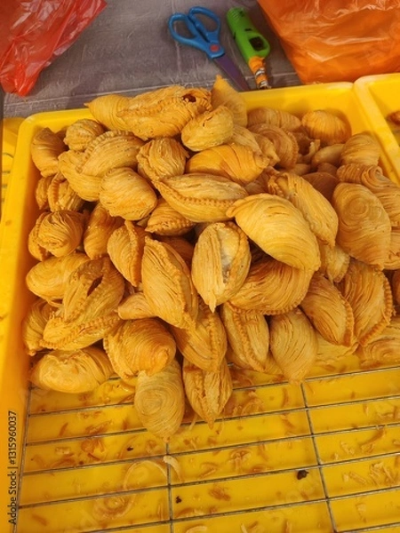 Fototapeta Vendor selling cuisine at street bazaar in Malaysia catered for iftar during Muslim fasting month of Ramadan