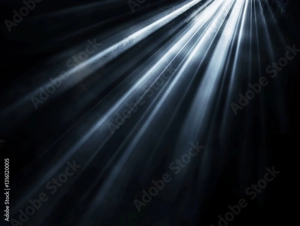 Fototapeta A black and white photo of a light beam of light shining through a dark room