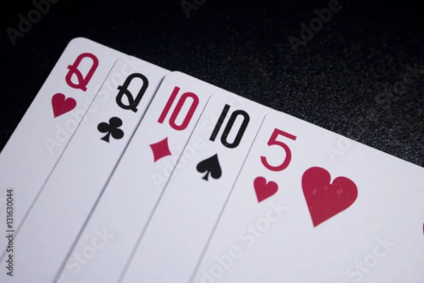 Fototapeta two pairs poker card on dark black background