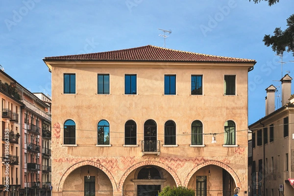 Obraz historic italian building with arched portico and warm facade in Treviso