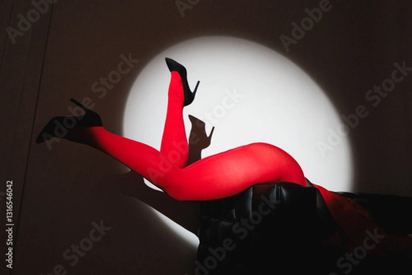 Fototapeta A striking and captivating silhouette featuring red legs and high heels, which creates a bold visual statement