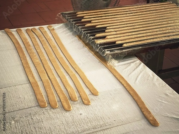 Obraz Coconut candy strips in a preform before cutting and packaging. Thoi Son Island coconut candy factory, Vietnam sweets.