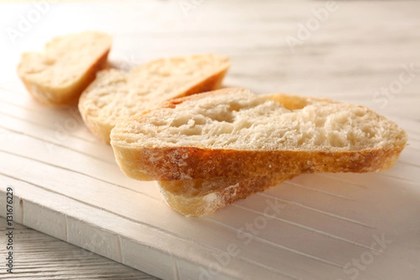 Fototapeta Sliced fresh bread on wooden background