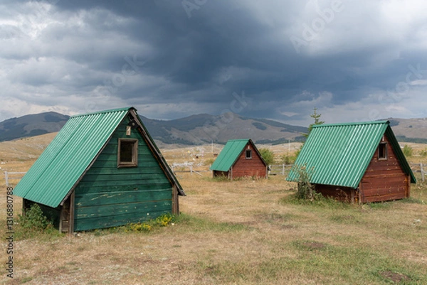 Fototapeta Trsa, Montenegro - 19 August 2024: Rustic wooden cabins in Durmitor Nationalpark
